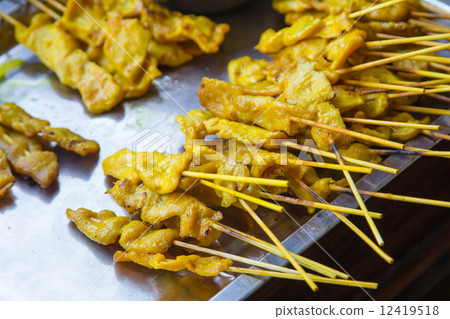 Satay chicken on grill. 12419518