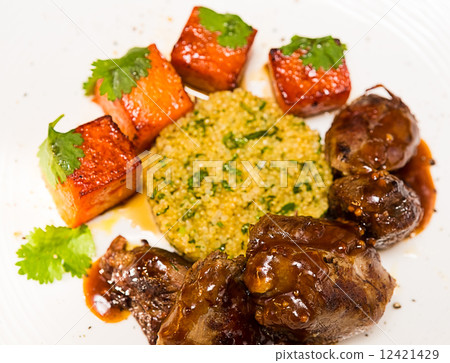 Organic meat of lamb cooked with slices pumpkin and quinoa in oriental style 12421429