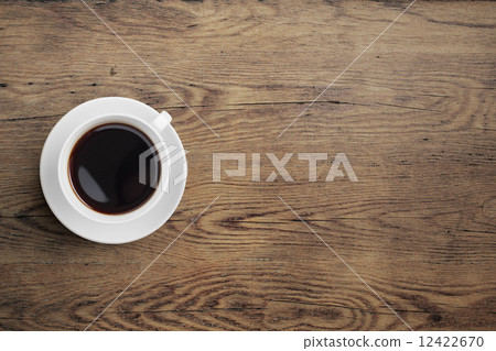 Black coffee cup on old wooden table top view 12422670