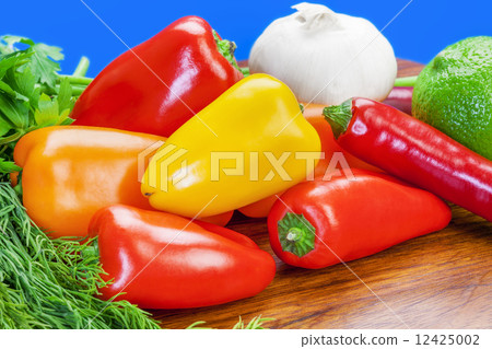 Peppers, garlic and lemon and herbs on the table Peppers, garlic and lemon and herbs on the table 12425002