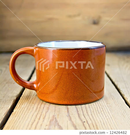 Mug brown on wooden board Mug brown on wooden board 12426482