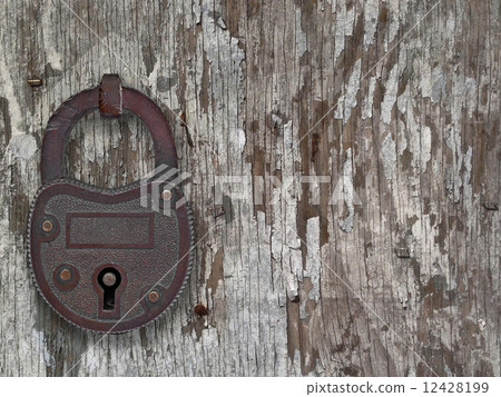 vintage padlock on a old door vintage padlock on a old door 12428199