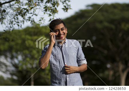 Young Asian with mobile phone 12428650