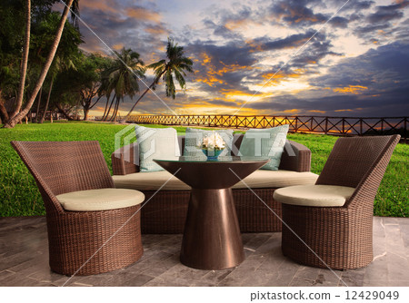 rattan chairs in outdoor terrace living room against beautiful s 12429049