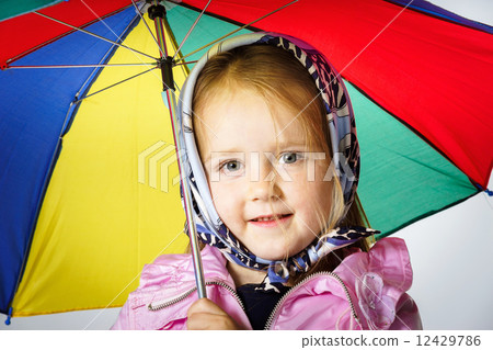 Cute little girl with colorful umbrella 12429786
