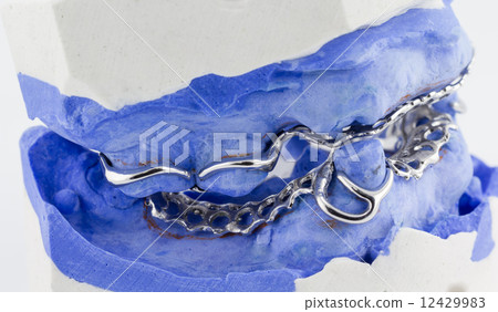 a partial denture on white background 12429983