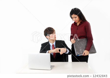 Asian female executive taking notes from boss or customer 12432843