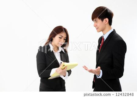 Asian female executive taking notes from boss or customer Asian female executive taking notes from boss or customer 12432848