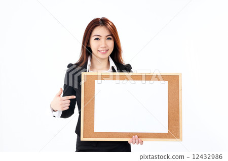 Female business executive holding notice board Female business executive holding notice board 12432986