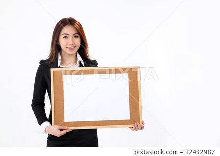 Female business executive holding notice board 12432987