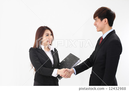 Asian businessman and woman shaking hands 12432988