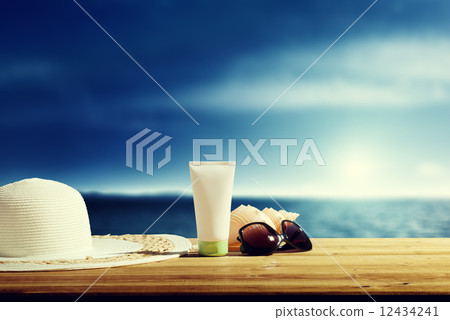 Sun lotion and sunglasses on the beach 12434241