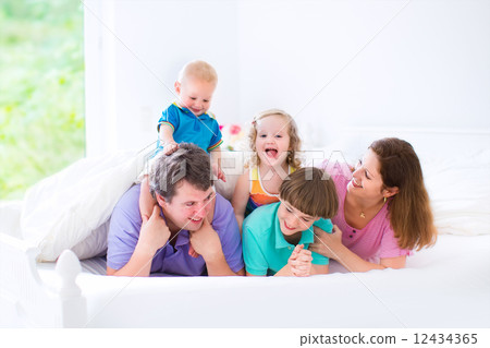 Happy big family in a bed 12434365