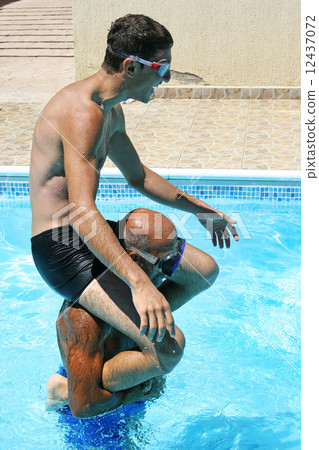Men in swimming pool Men in swimming pool 12437072