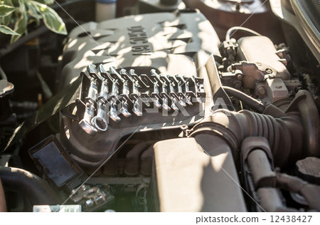 set of tools lying on car engine 12438427