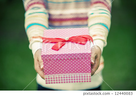 Male hands holding and giving gift 12440083
