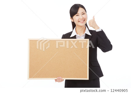 A business woman who brings a good sign with a message board 12440905
