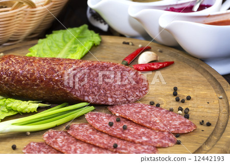sausages on a wooden plate with vegetables in a restaurant 12442193
