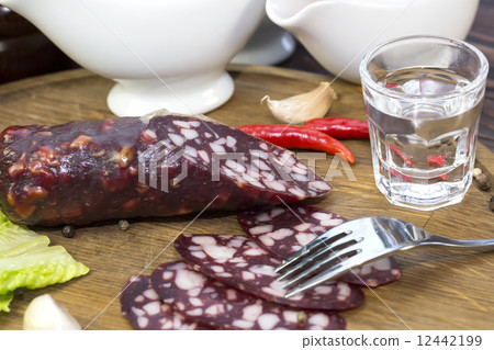 sausages on a wooden plate with vegetables in a restaurant 12442199