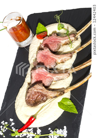 lamb ribs cooked on the grill served on a hot stone lamb ribs cooked on the grill served on a hot stone 12442403