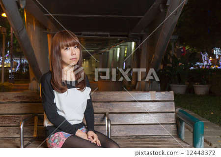 Sad Asian Woman on a Park Bench Sad Asian Woman on a Park Bench 12448372