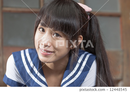 Asian schoolgirl standing in front of school Asian schoolgirl standing in front of school 12448545