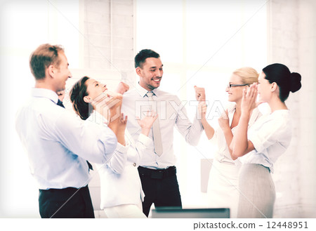 business team celebrating victory in office business team celebrating victory in office 12448951