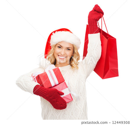 woman in santa helper hat with shopping bags 12449308