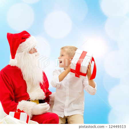 smiling little boy with santa claus and gifts 12449313