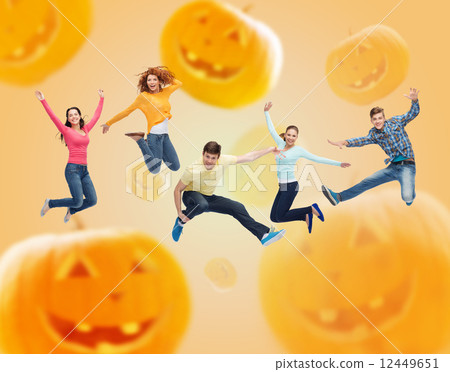 group of smiling teenagers jumping in air 12449651