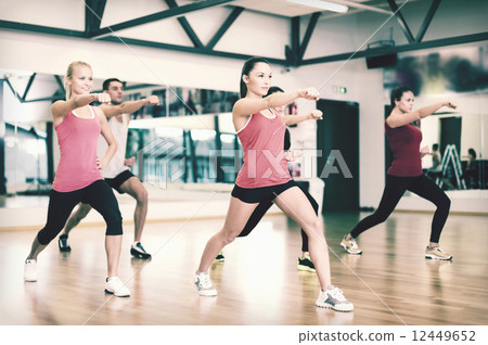 group of smiling people exercising in the gym group of smiling people exercising in the gym 12449652