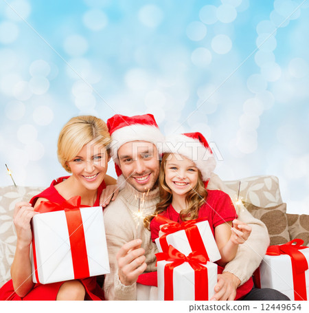 happy family in santa helper hats with gift boxes happy family in santa helper hats with gift boxes 12449654
