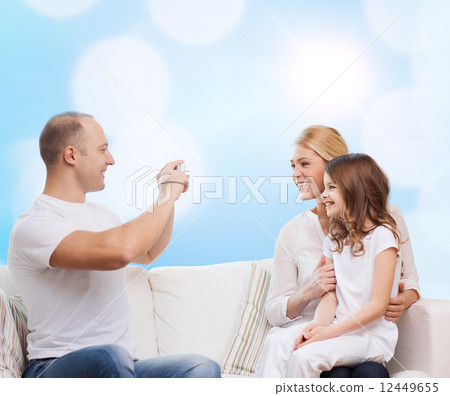 happy family with camera at home 12449655
