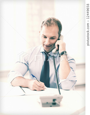 handsome businessman talking on the phone handsome businessman talking on the phone 12449658