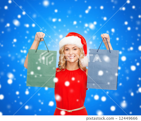 woman in santa helper hat with shopping bags woman in santa helper hat with shopping bags 12449666