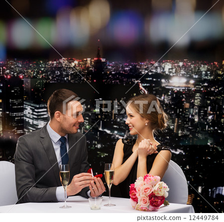 man proposing to his girlfriend at restaurant man proposing to his girlfriend at restaurant 12449784