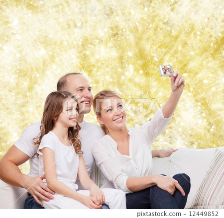 happy family with camera at home 12449852
