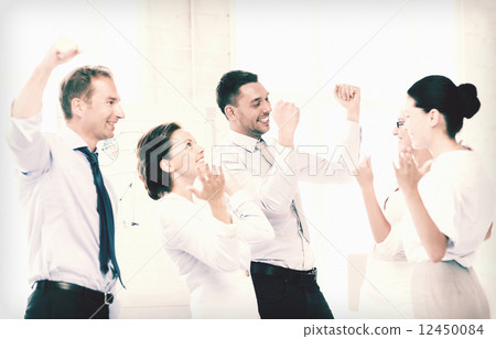 business team celebrating victory in office business team celebrating victory in office 12450084
