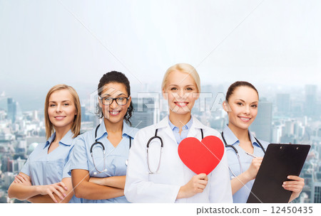 smiling female doctor and nurses with red heart 12450435