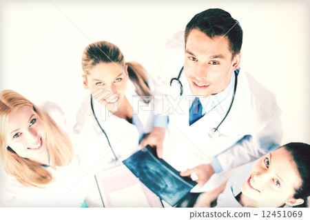 young group of doctors looking at x-ray 12451069