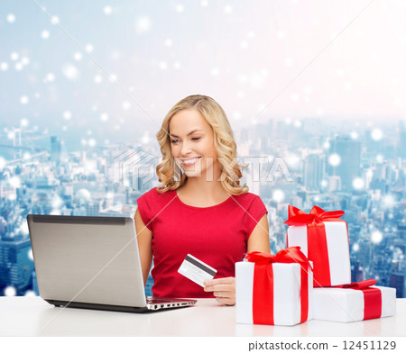 smiling woman with credit card and laptop smiling woman with credit card and laptop 12451129