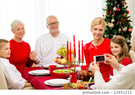 smiling family having holiday dinner at home 12451211