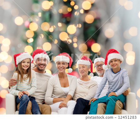 happy family in santa helper hats sitting on couch happy family in santa helper hats sitting on couch 12451283