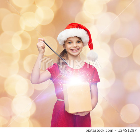 smiling girl in santa helper hat with gift box smiling girl in santa helper hat with gift box 12451287