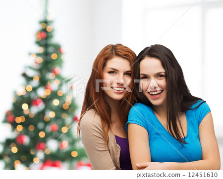 smiling teenage girls hugging 12451610