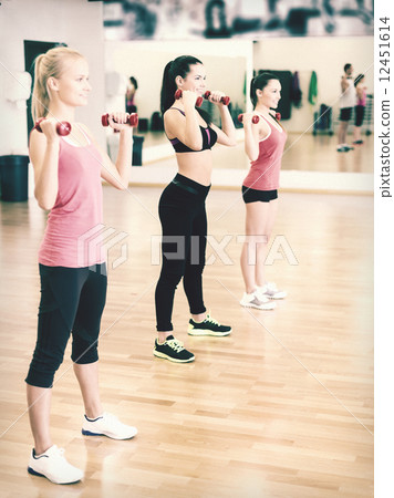group of smiling people working out with dumbbells 12451614