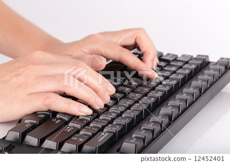 Female hands typing on computer keyboard 12452401
