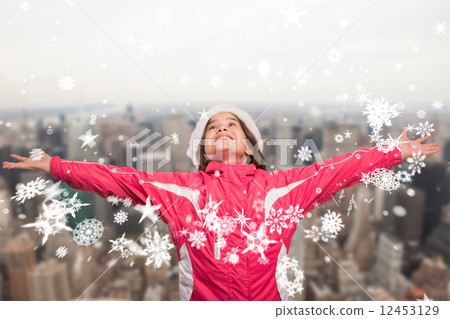 Composite image of cute girl in winter clothes with arms out 12453129