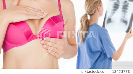 Woman performing self breast examination 12453778