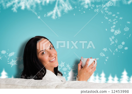 Composite image of woman enjoying a lovely drink 12453998